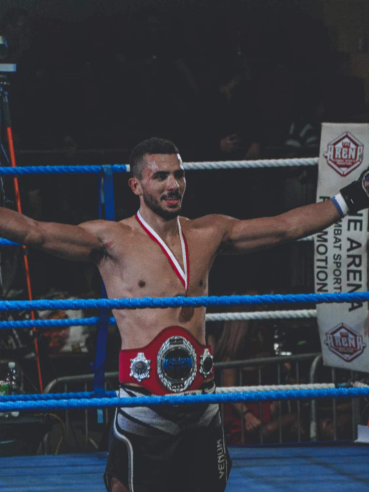 Ruud Chircop holding his MMA championship belt after a competition win
